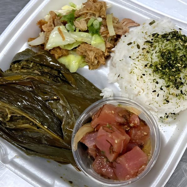 Poke Etc. plate lunch with poke, kalua pig, lau lau, and rice in a white takeout container.
