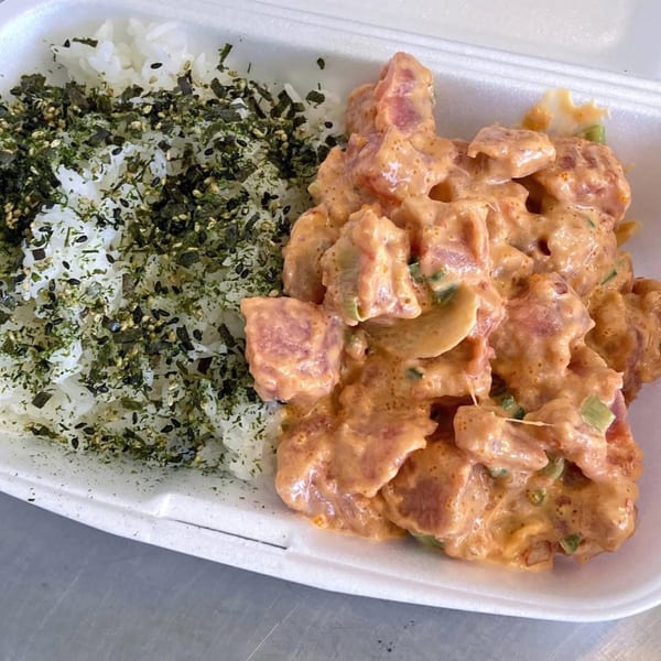 Poke Etc's spicy poke bowl with white rice topped with furikake and creamy orange poke.